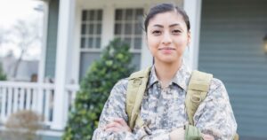soldier in front of house