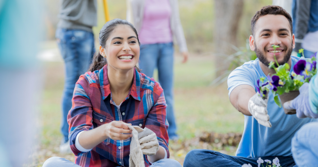 A woman in a community gardening smiling